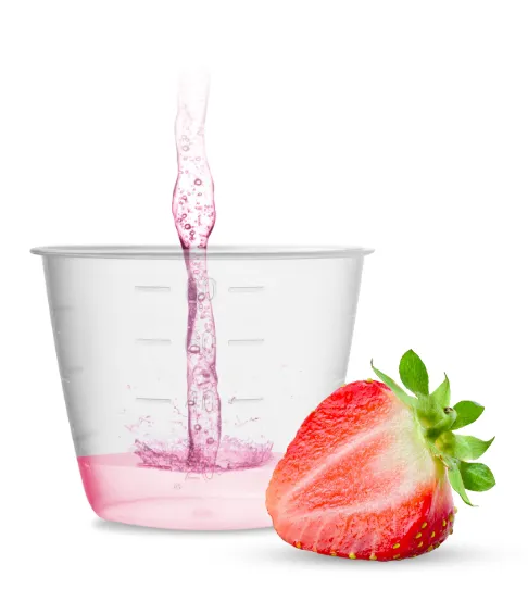 Cut strawberry and plastic medicine measuring cup filled part way with KONVOMEP strawberry flavored liquid omeprazole.